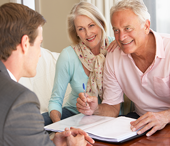 A man seated on a couch, engaged in discussions about estate planning
